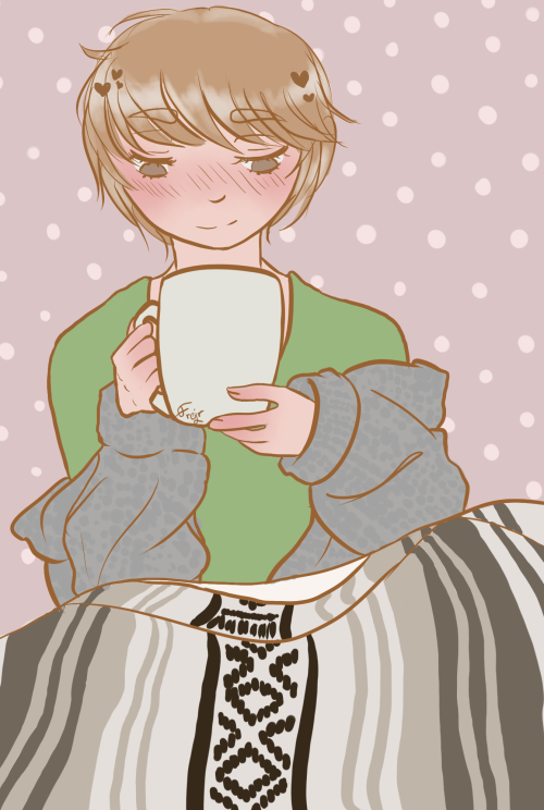 Guang Hong from Yuuri on Ice, sitting with his legs under a blanket, holding a big mug in his hand. He's smiling down at it, wearing a green shirt and a grey cardigan.