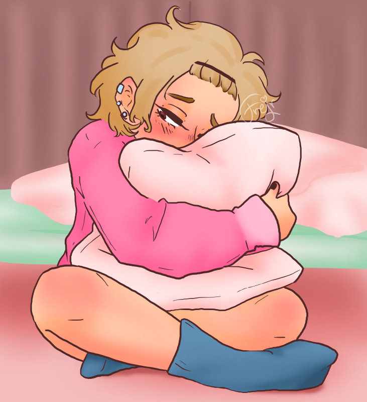JK from Kamen Rider Fourze, sitting crosslegged on the floor, hugging a pillow, lower half of his face buried in it. She's looking a bit sad and flustered. She's wearing a pink sweater and blue socks and shorts.