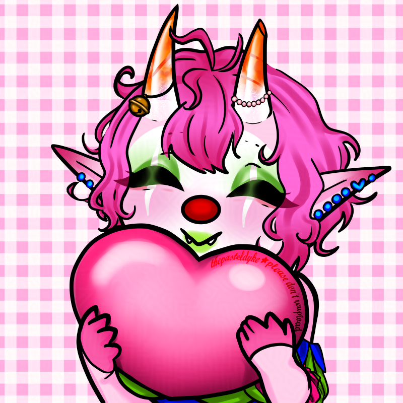 A digital drawing of a clown in chibi style from the chest up with pink skin and short pink hair, long pointy ears full of piercings and horns growing out of her forehead. The horns are semi-transparent at the base, and orange at the tips. The tip of the left horn cut off. She's wearing a choker attached to blue bunting draped around her shoulders and above her cleavage. The bunting is attached to puffy sleeves in green and pink ribbons and you can see a green and pink bra.  She's holding a big pink heart in her hands, eyes closed and smiling with her mouth shaped like a V.